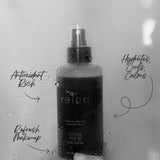 Bottle of 'reign' cooling mist held against a foggy glass background. Handwritten notes surrounding the product that highlight the benefits of the product.