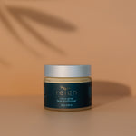 Jar of Reign Citrus Glow face moisturiser with 'reign' branding on a warm background