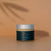 Jar of Reign Citrus Glow face moisturiser with 'reign' branding on a warm background
