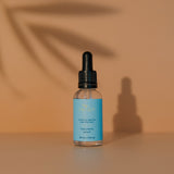 Skincare Reign Hyaluronic serum bottle with dropper on a warm background